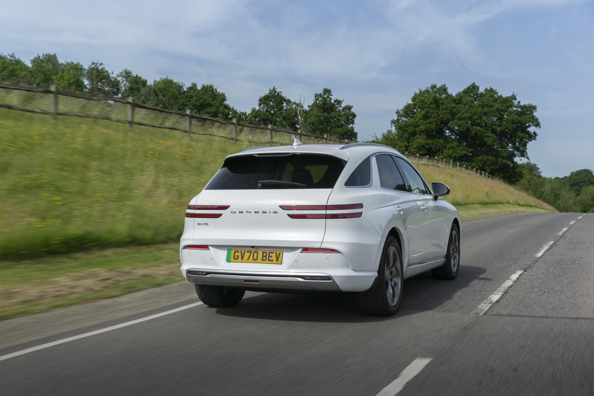 White Electrified GV70 Sport Line on a road