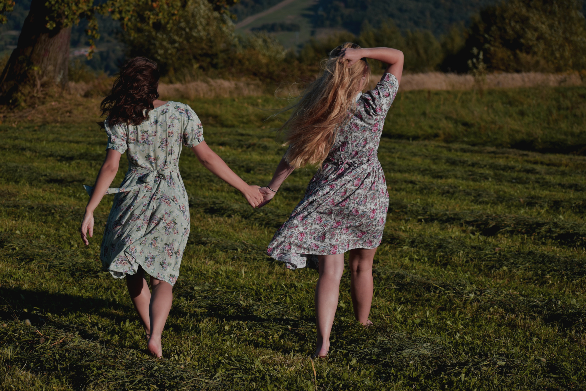 Two women running in a field