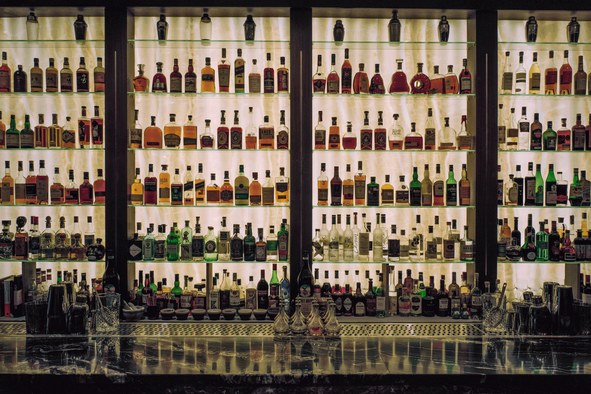 Bar with lit shelves of alcohol