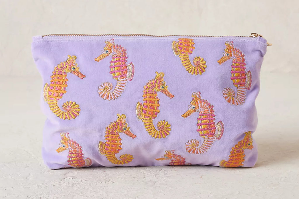 Purple pouch with orange seahorses embroidered on the front
