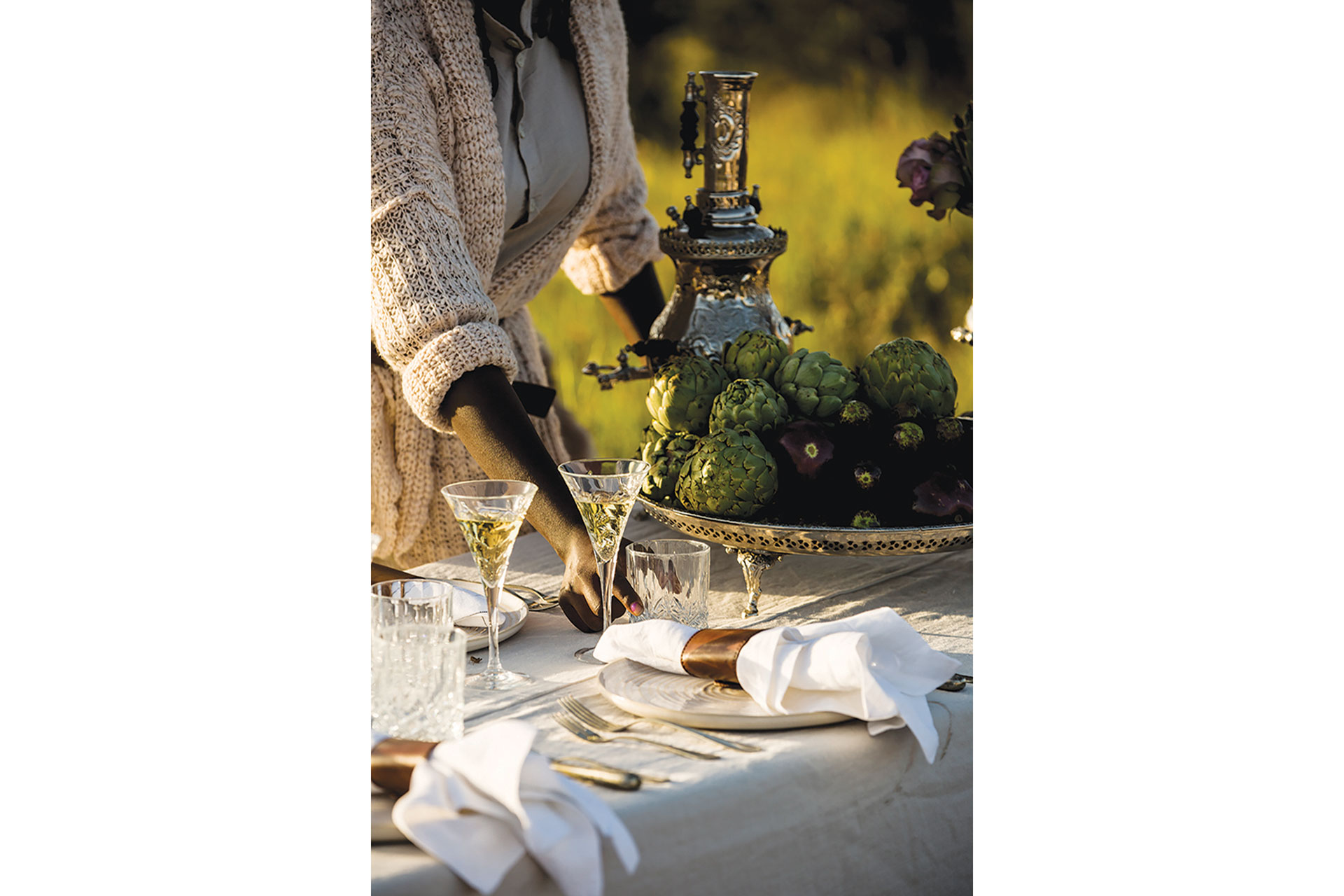 Woman laying a table outdoors