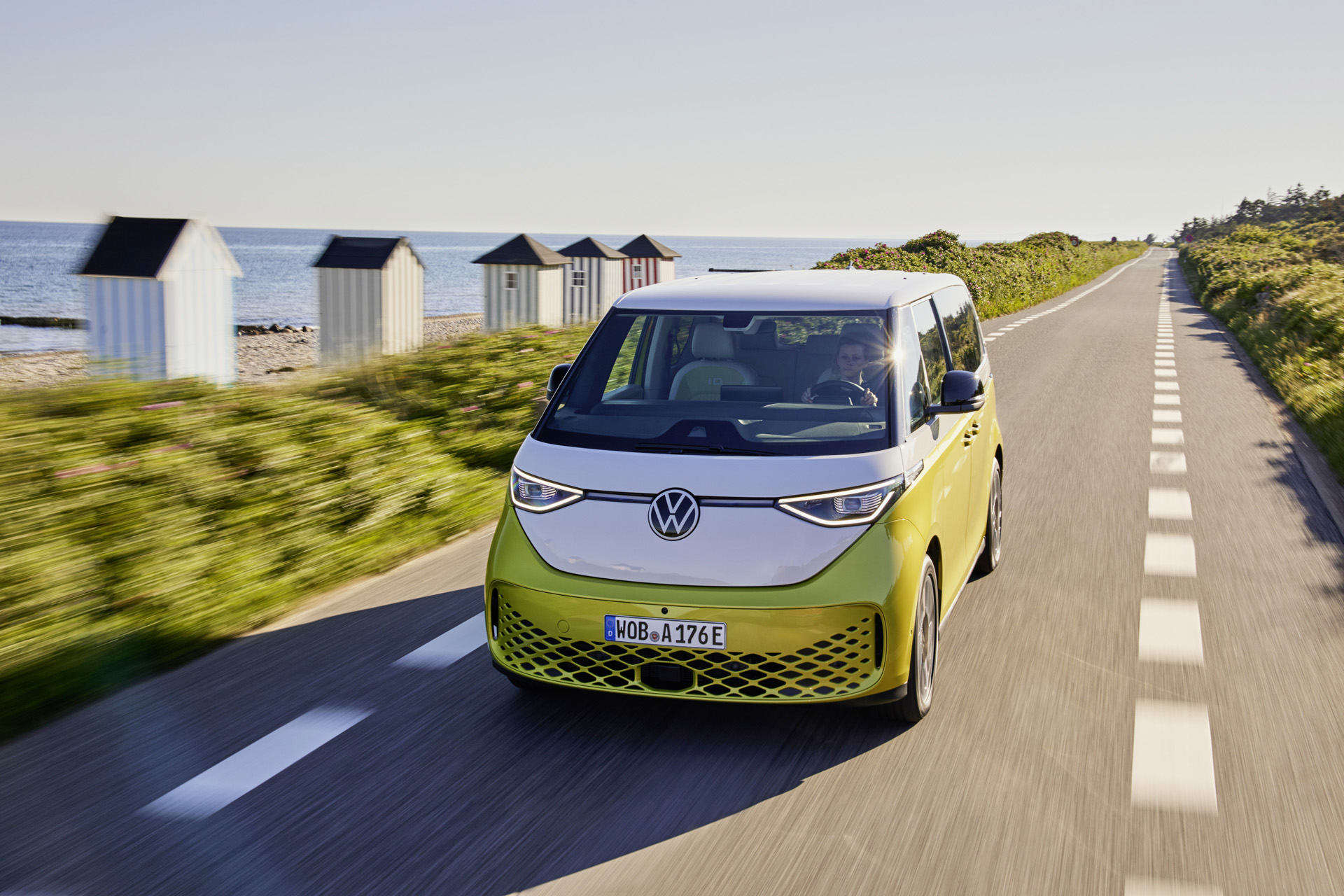 A yellow Volkswagen ID Buzz on a beachside road