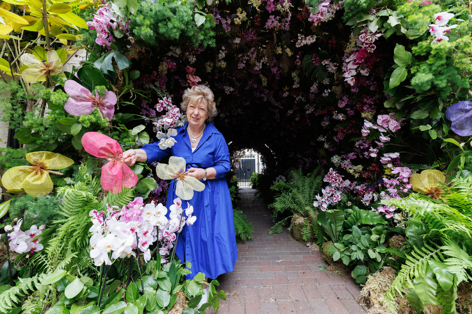 Florist Judith Blacklock puts the finishing touches to a floral installation, ‘Orchids and Butterflies by Judith Blacklock Flower School, in Kinnerton Street, London, which has been designed for the Belgravia in Bloom festival