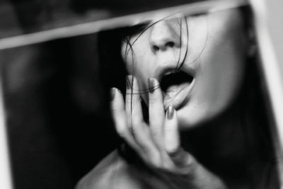 Close up of woman's face as she wipes her lips