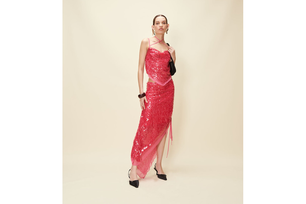 Woman in pink sequin top and skirt