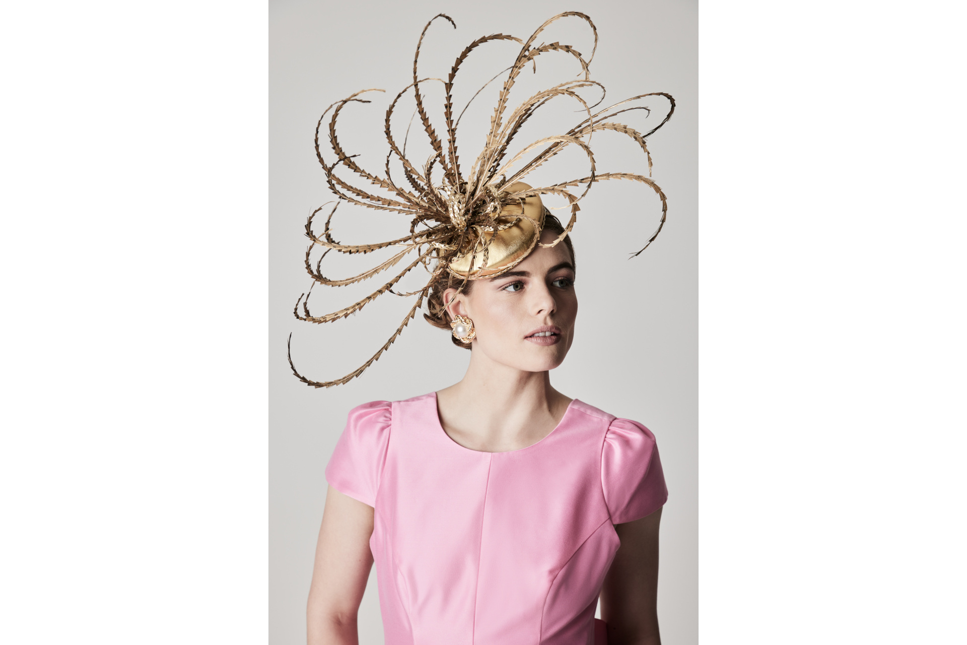 Woman in gold headpiece and pink top
