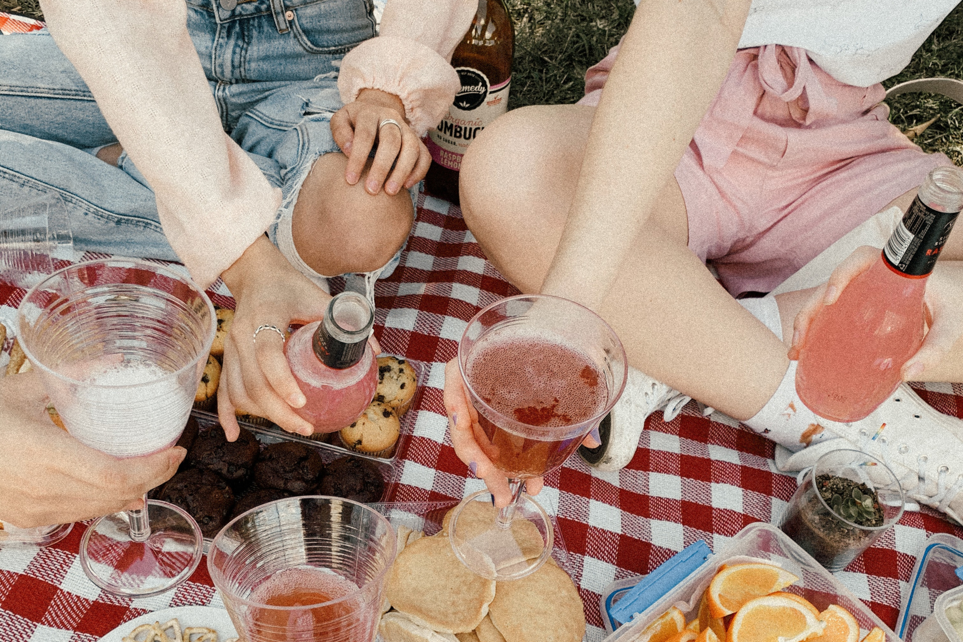 Close up of people sat on picnic blanket