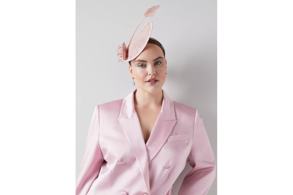 Woman in pink suit and fascinator