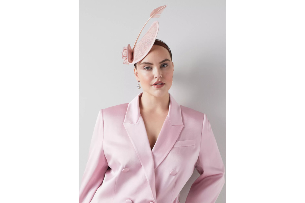 Woman in pink suit and fascinator