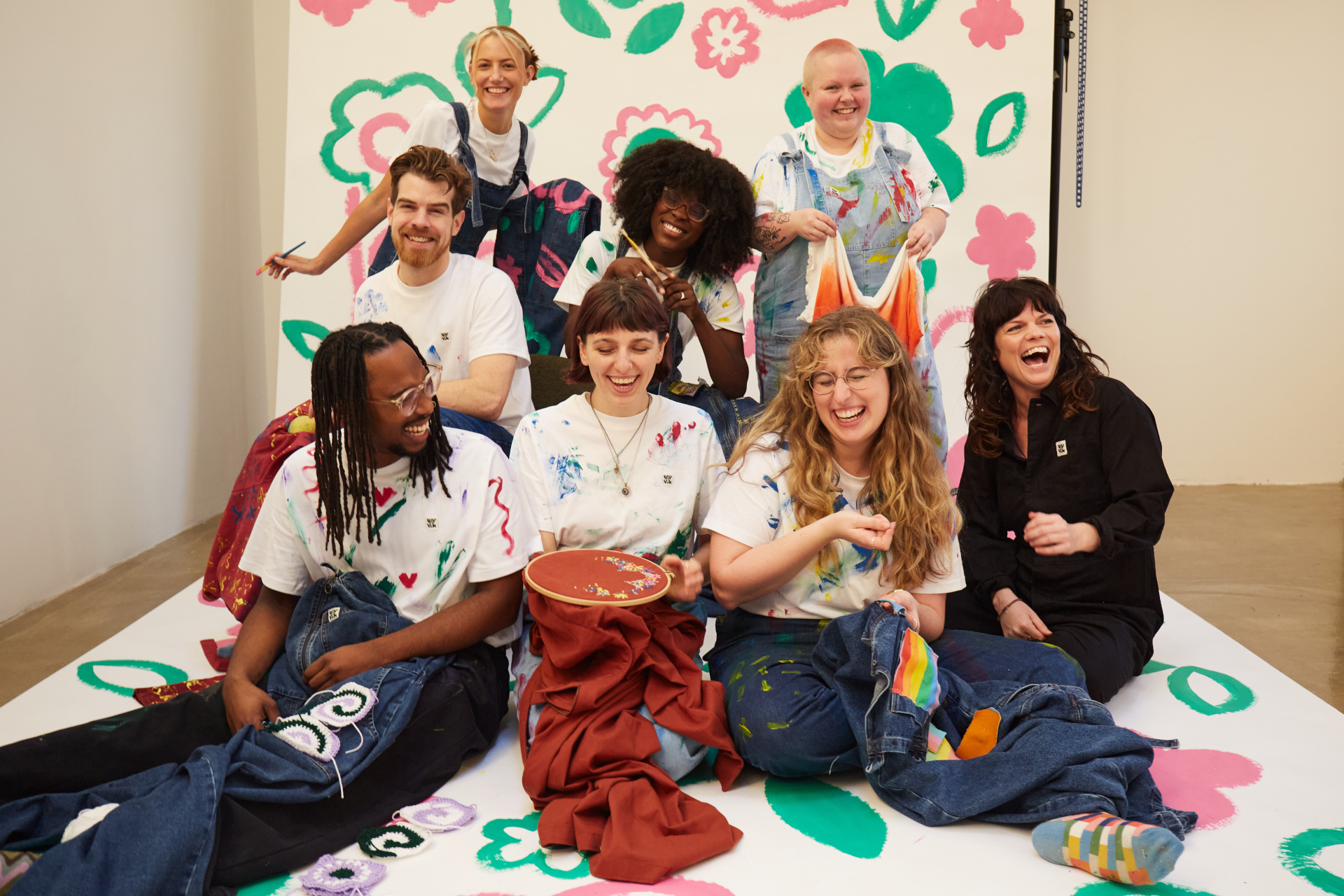 Lucy Greenwood with models holding upcycled clothing