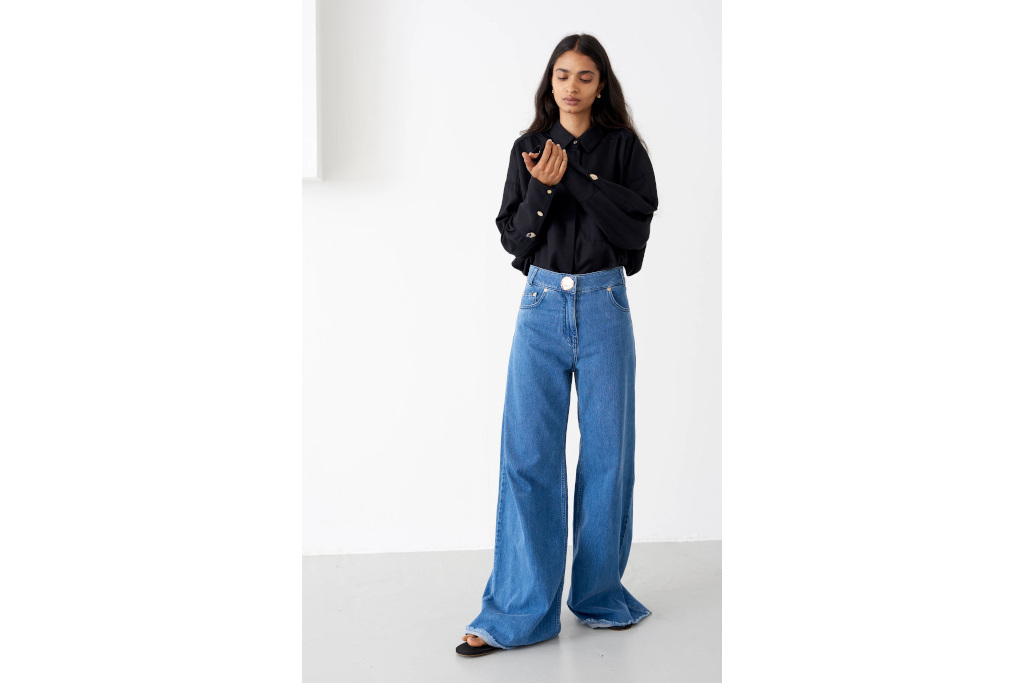 Woman in black top and blue jeans