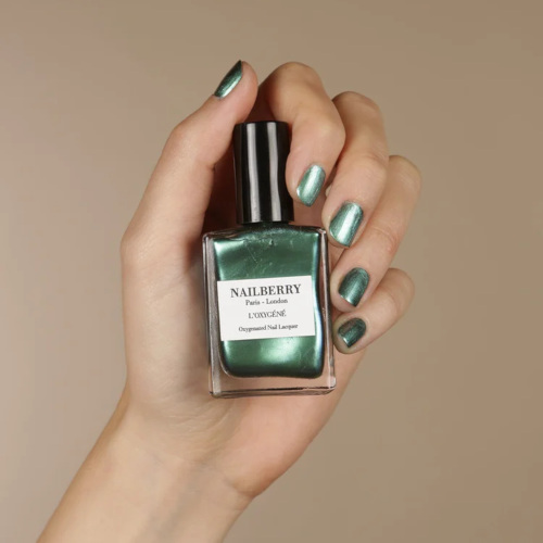 Hand holding green bottle | vegan nail brands