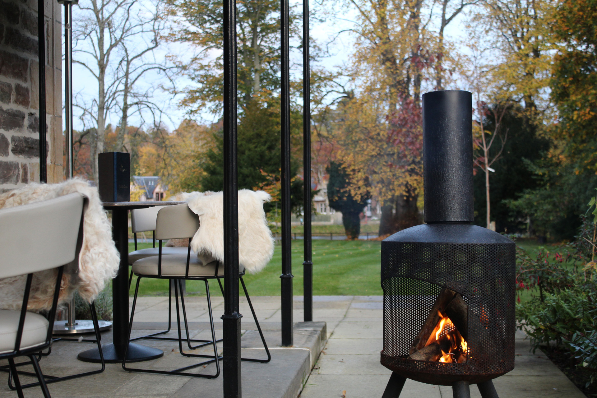 An outdoor firepit with sheepskin rugs