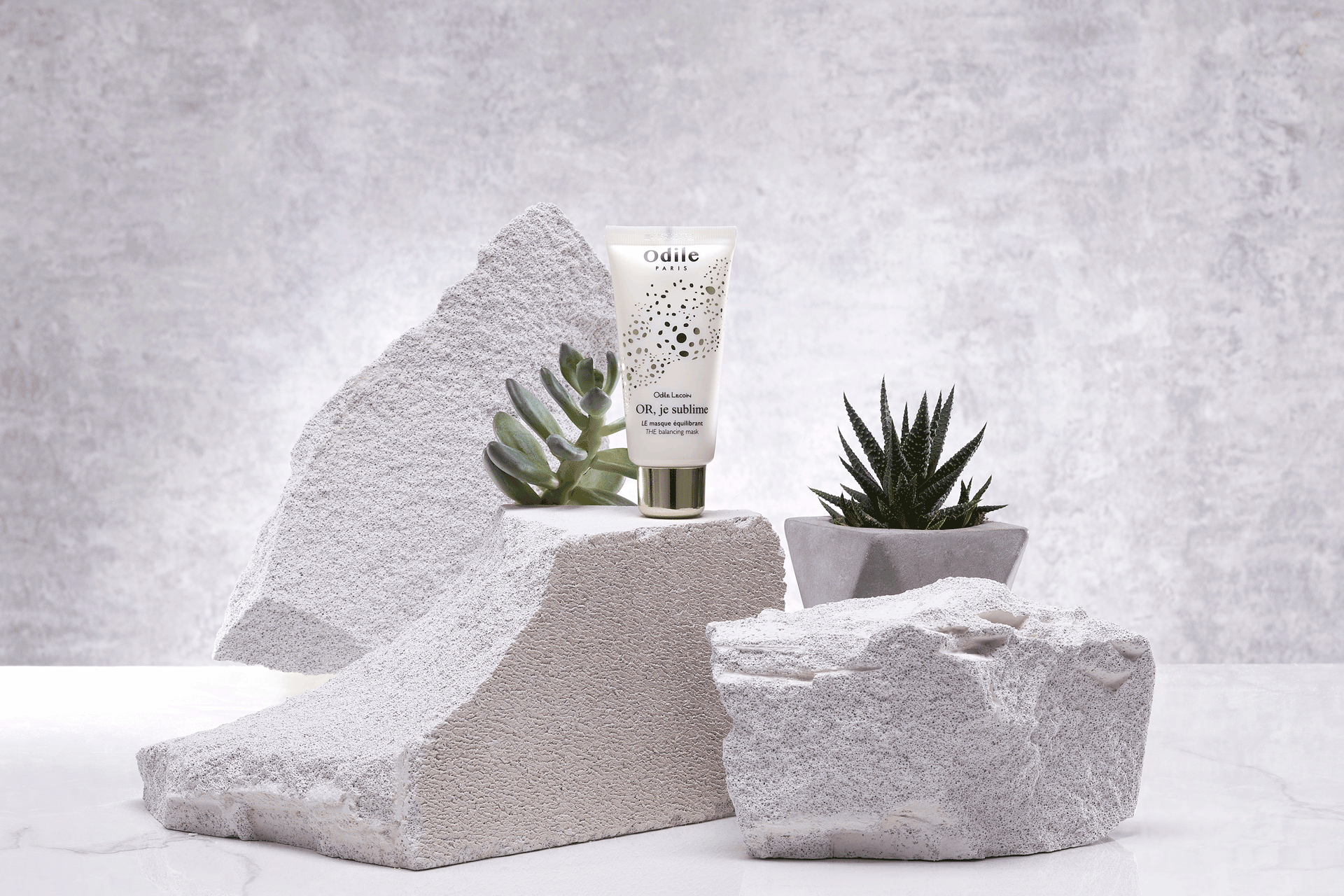 Odile skincare products in front of a grey background.