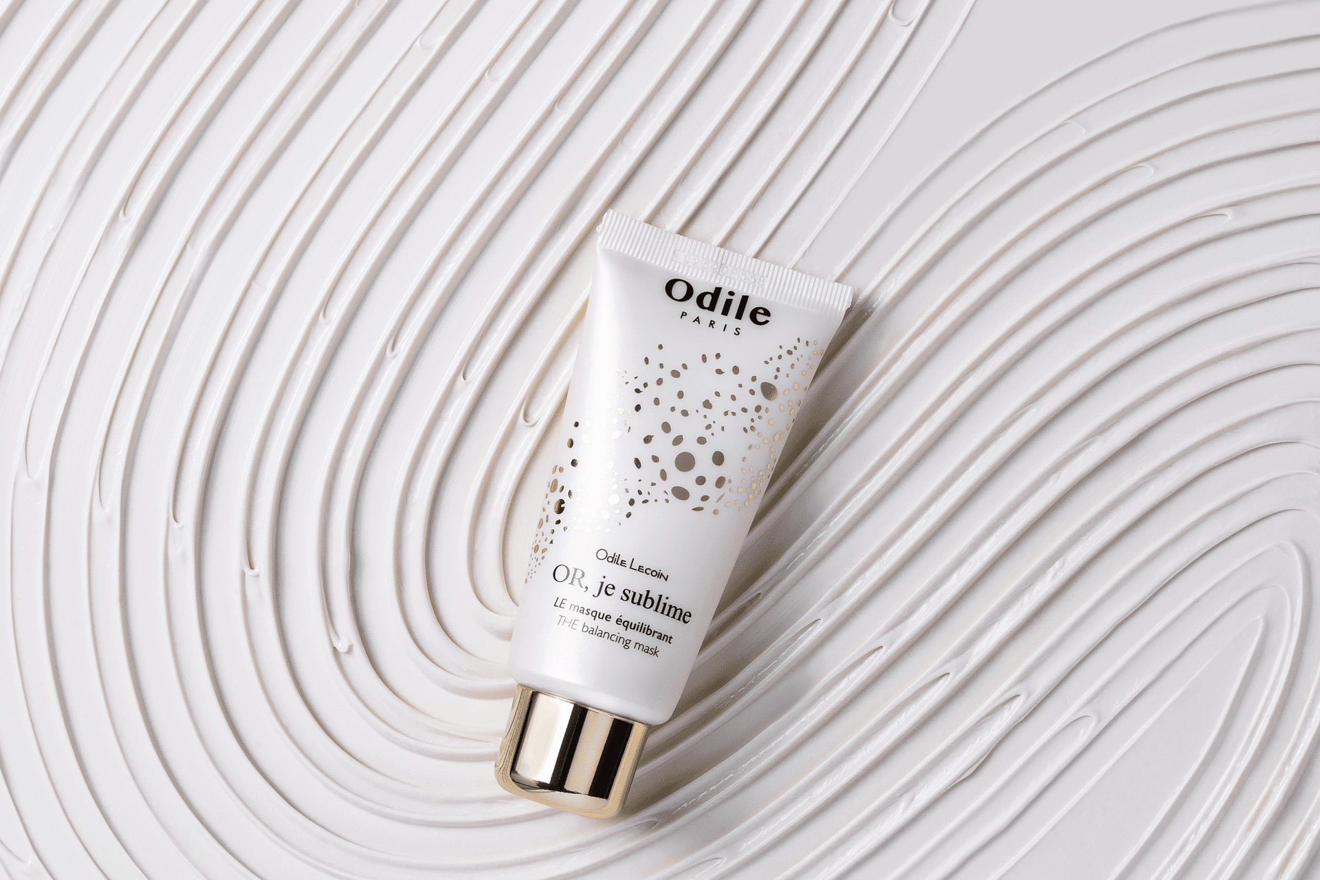 Odile skincare product in front of a patterned white packground.