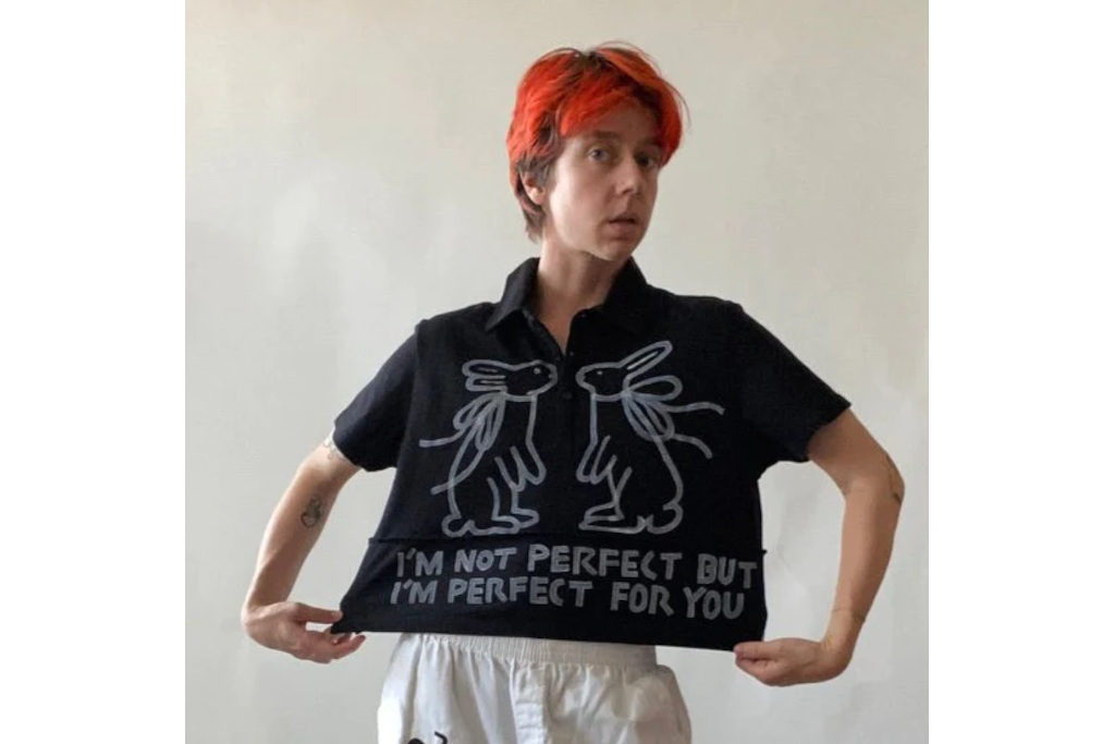 Model in black shirt and white trousers