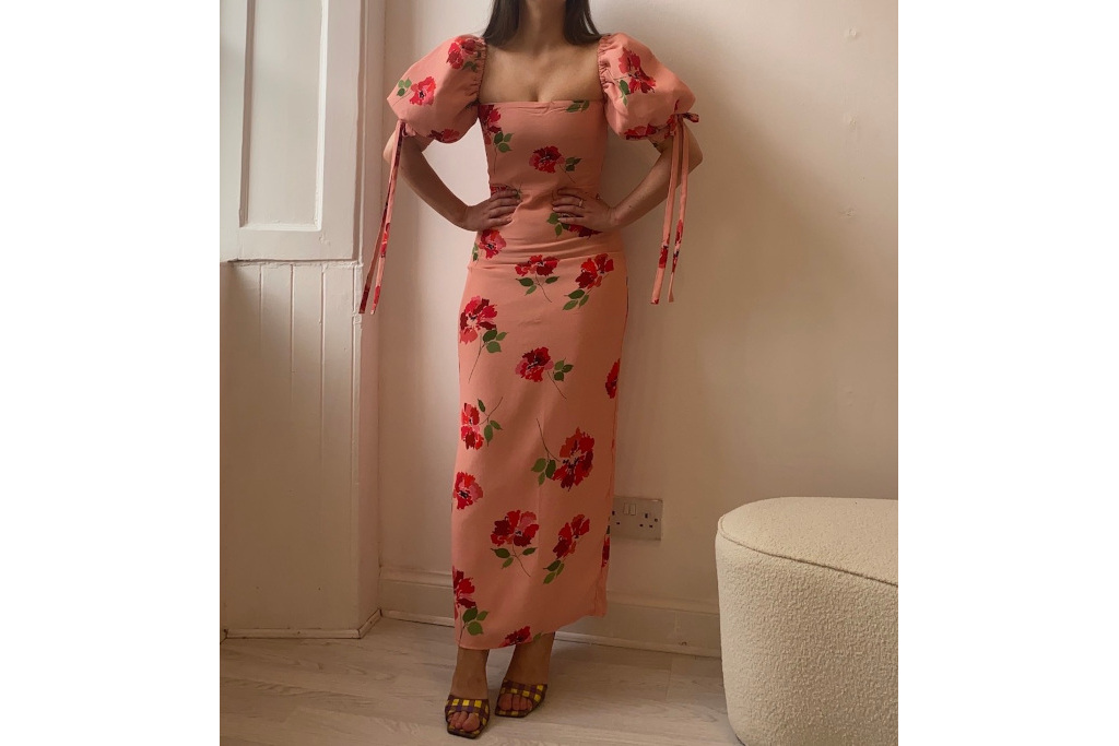 Woman in pink dress with red rose print