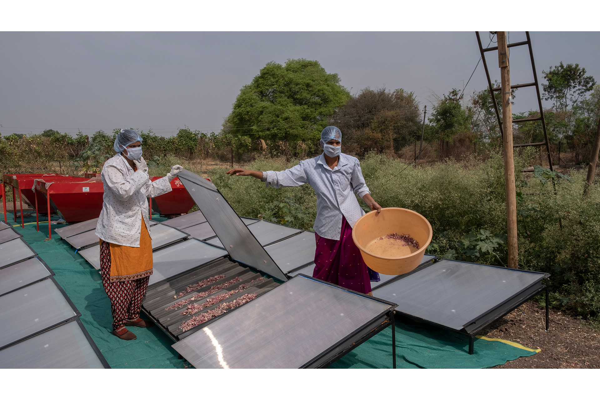 People in protective hear look at solar panels