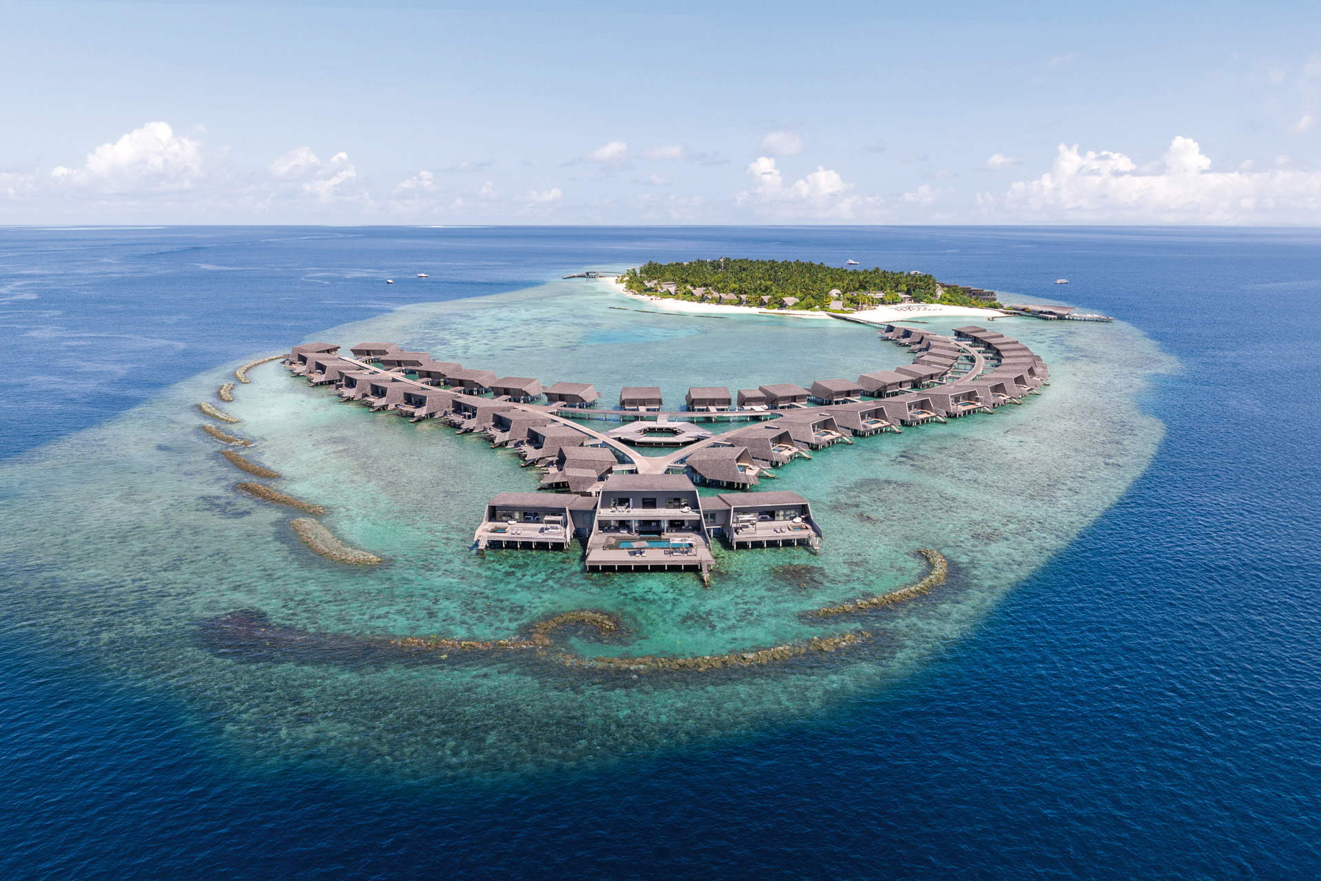 An aerial shot of overwater villas at the St Regis Vommuli, Maldives