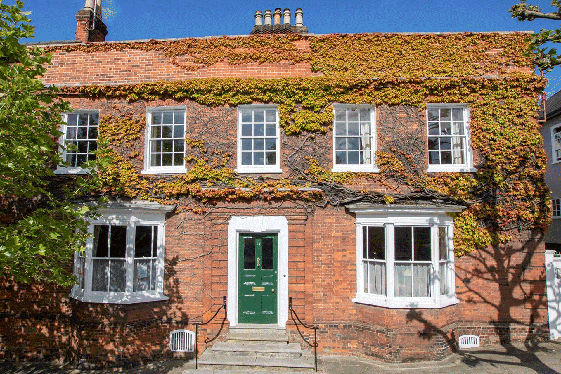 Virginia creeper-clad red brick Georgian home.