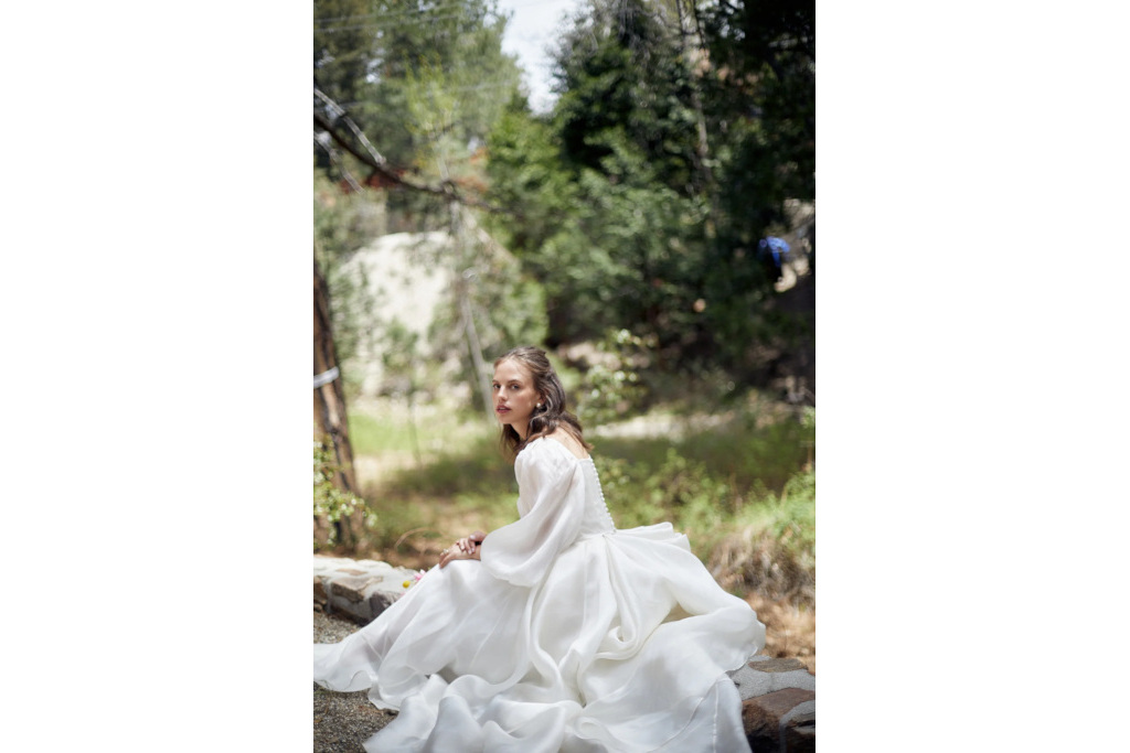 Woman in field wearing white dress