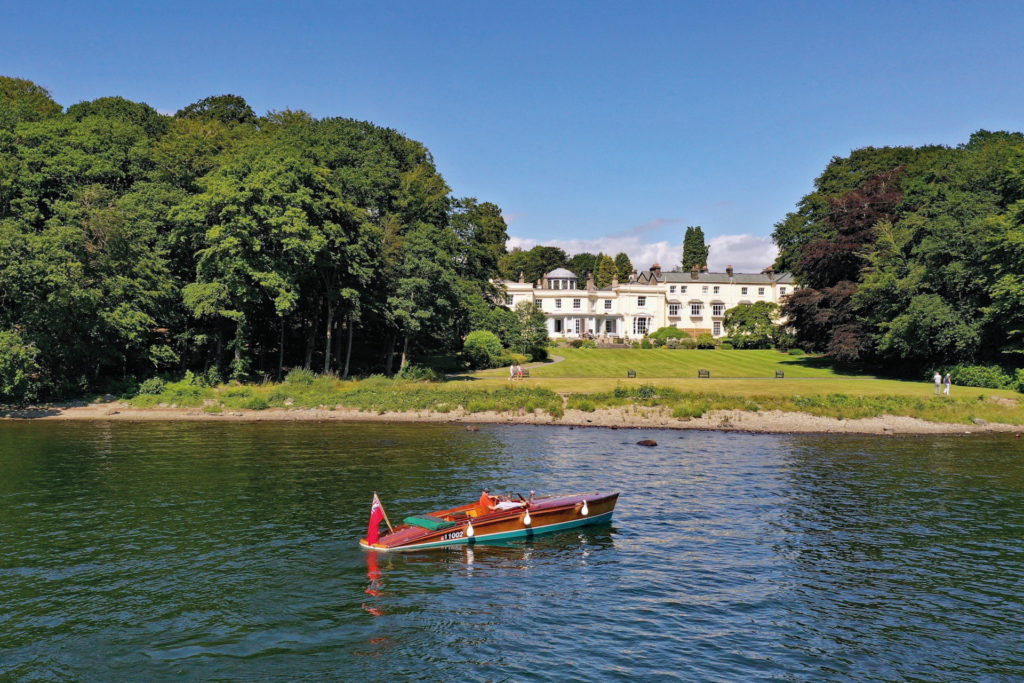 Canoe on lake in front of white hall