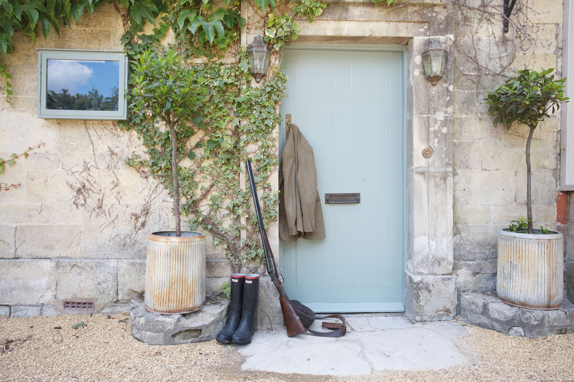 The front of the Beckford Arms - a pair of wellies and a jacket sit in front of a door