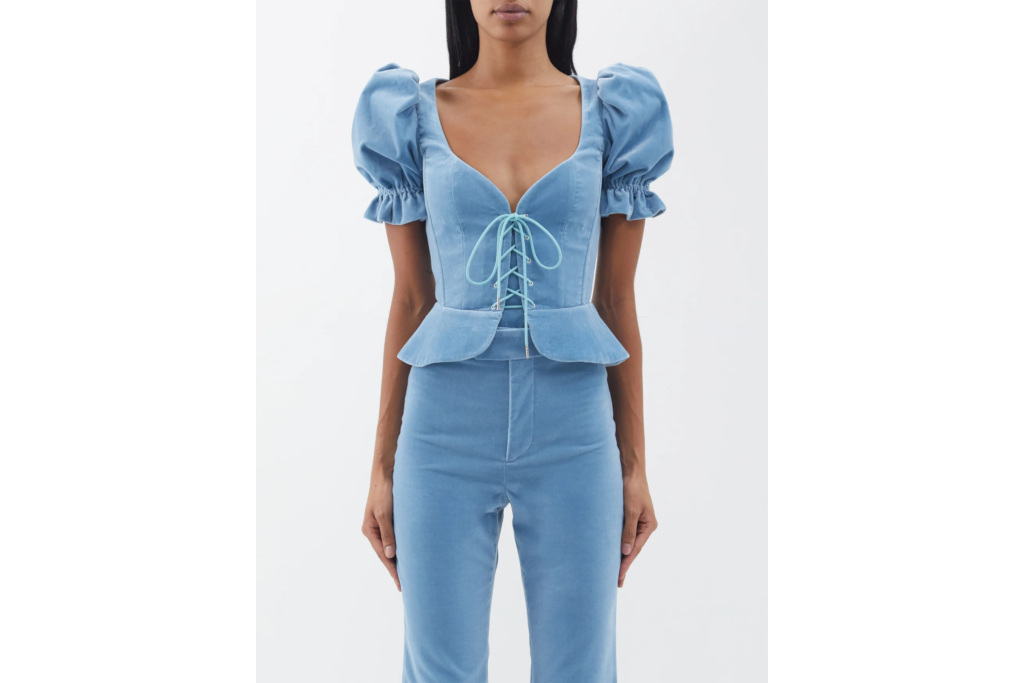 Woman in blue velvet corset and matching trousers