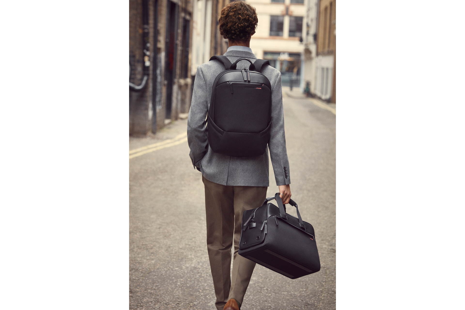 Man carrying rucksack and holdall