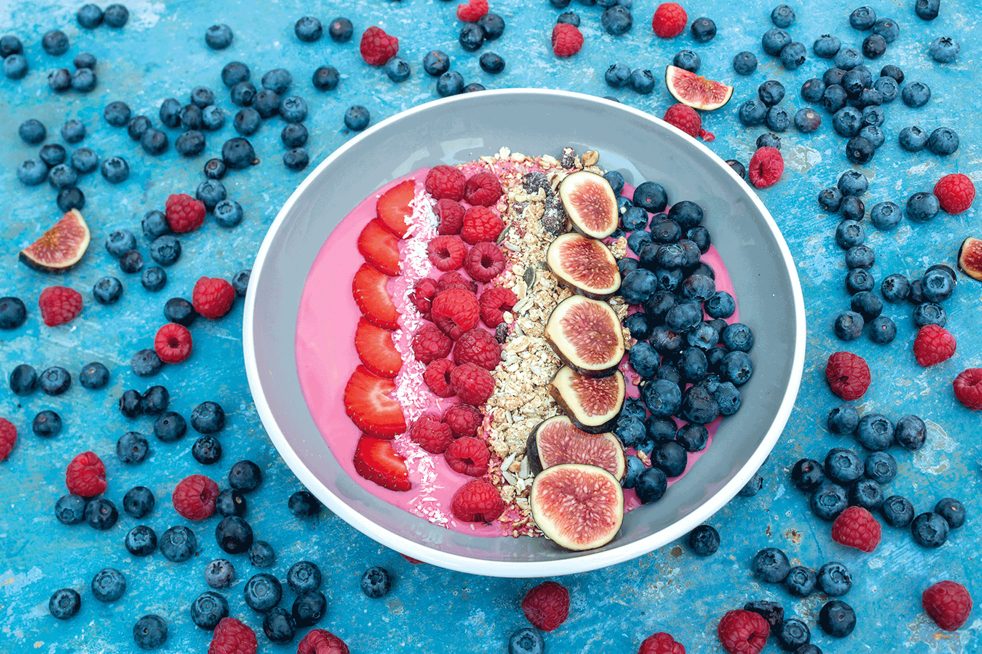 Acai bowl on a blue tabletop.