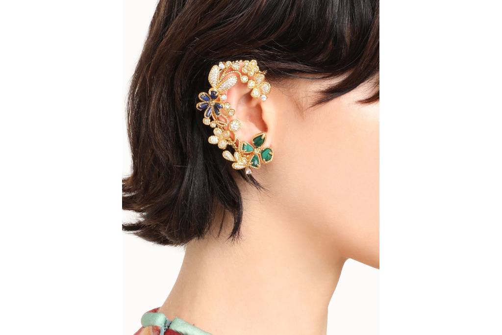 Close up of woman's ear with gold cuff on it