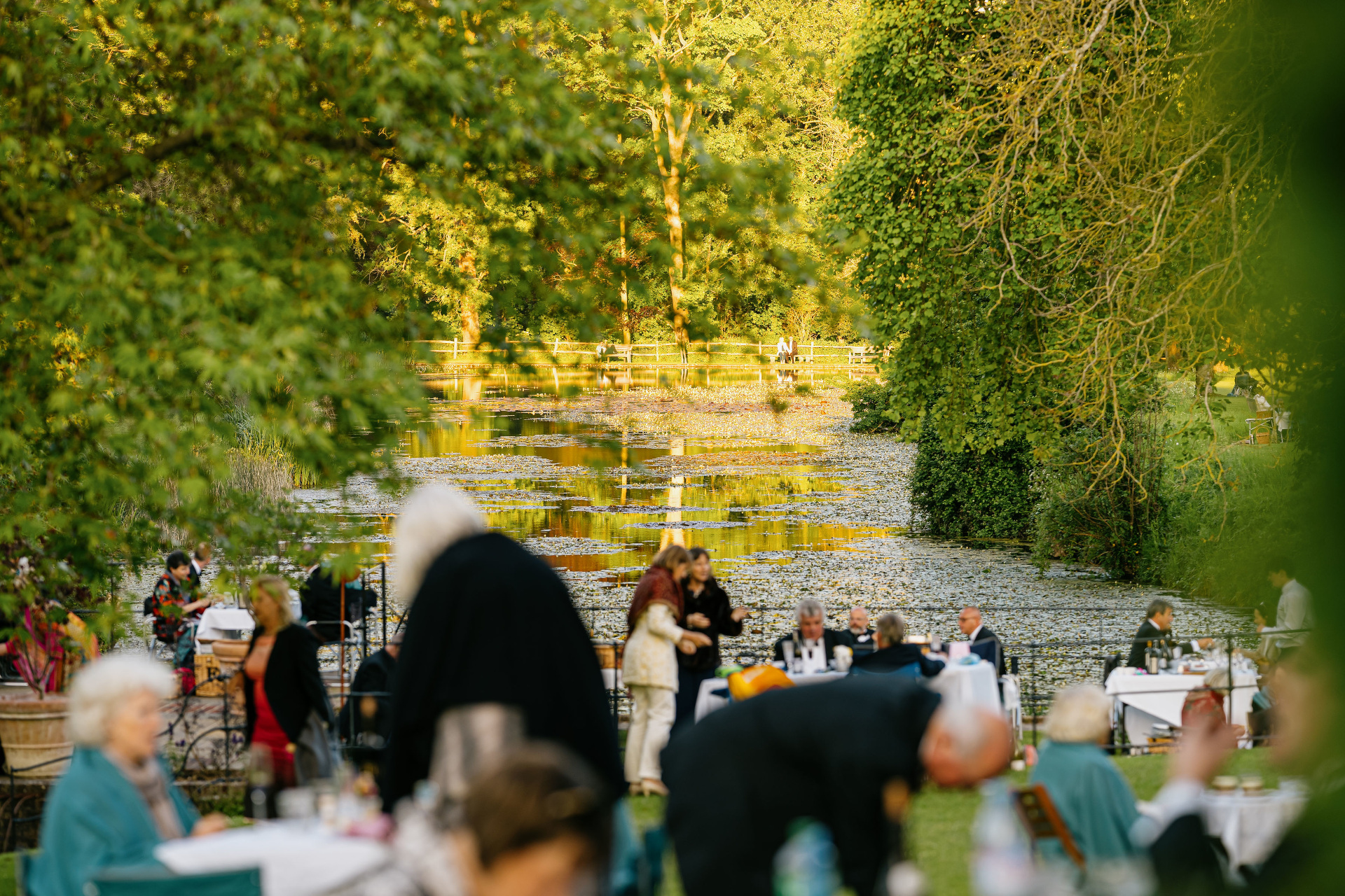 People sat by pond