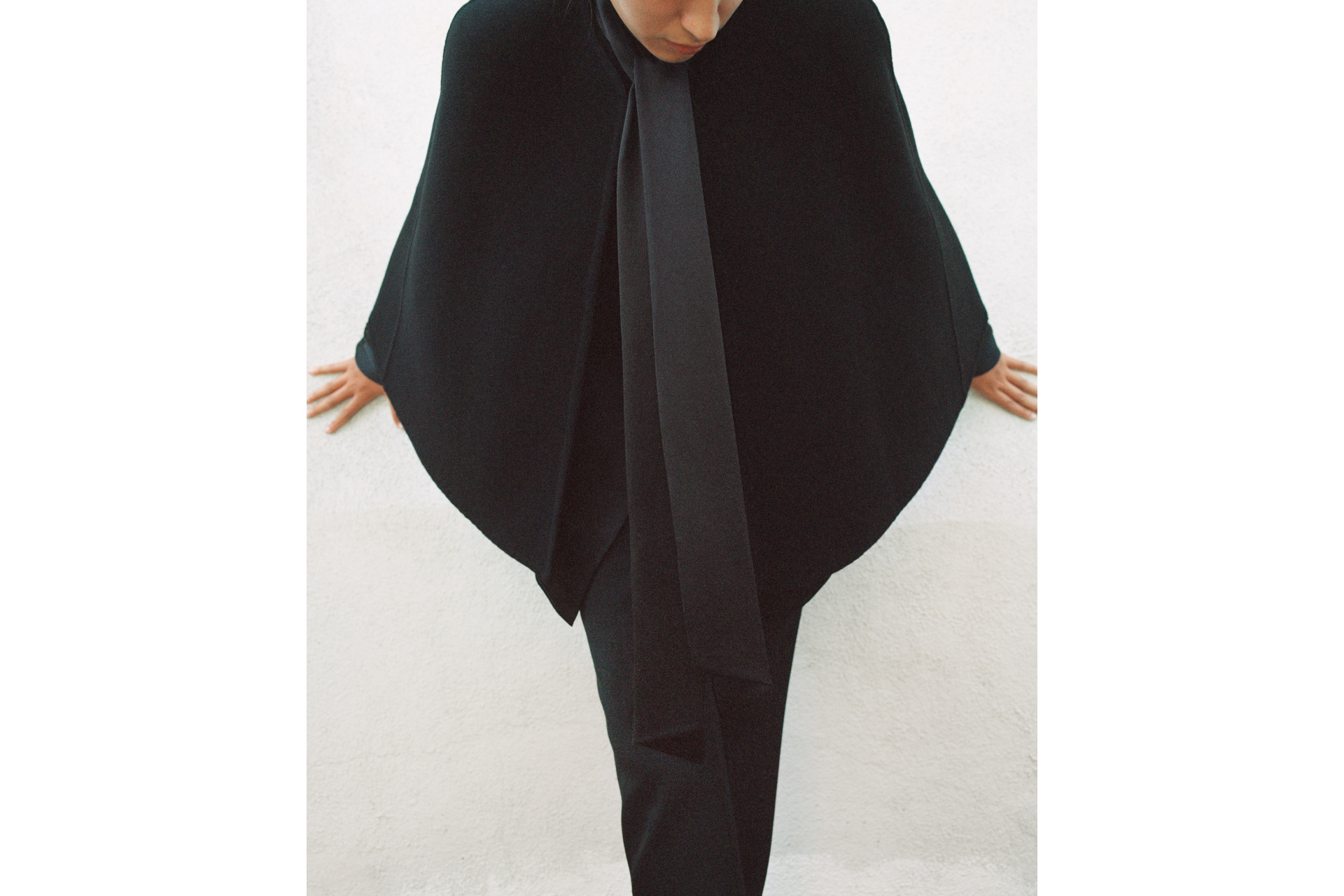 Woman in black dress with cape