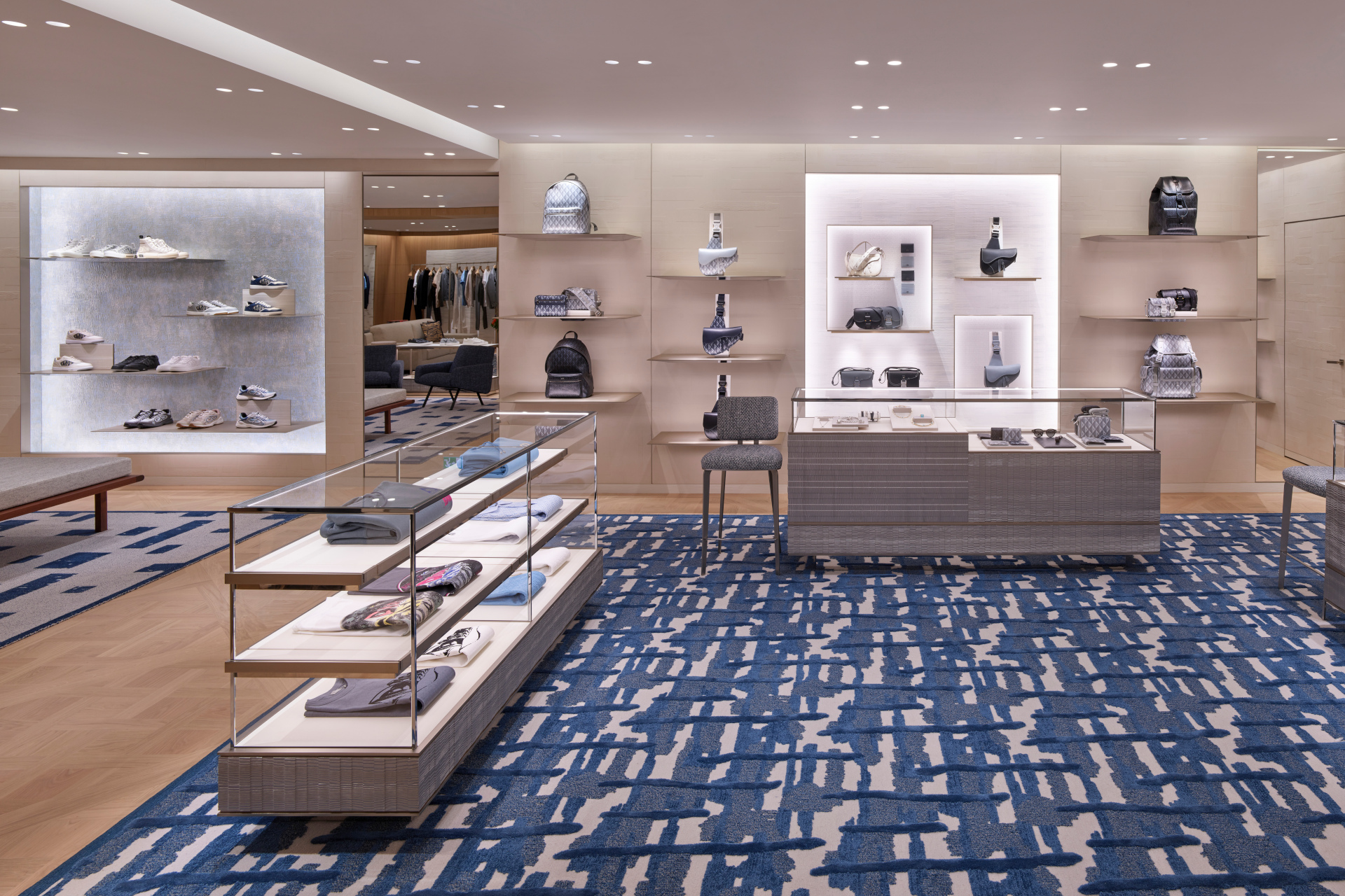 Menswear on display in shop, with blue carpets