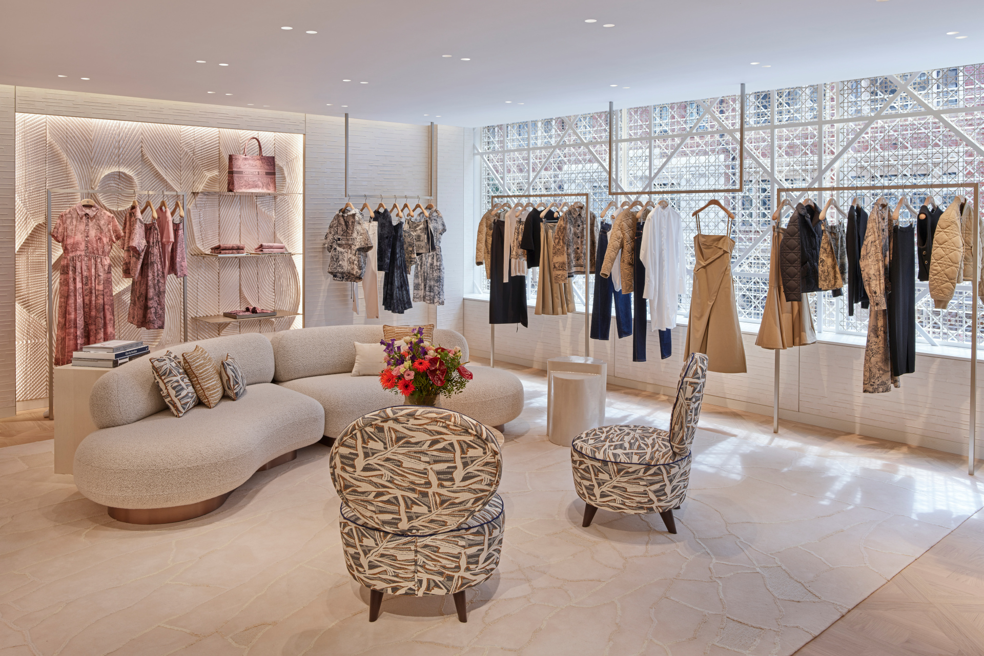 Sitting area with clothes on hangers and bags on display