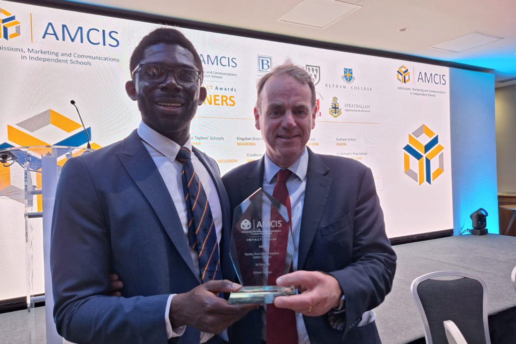 Gideon Hammond collecting the award on behalf of Eltham College