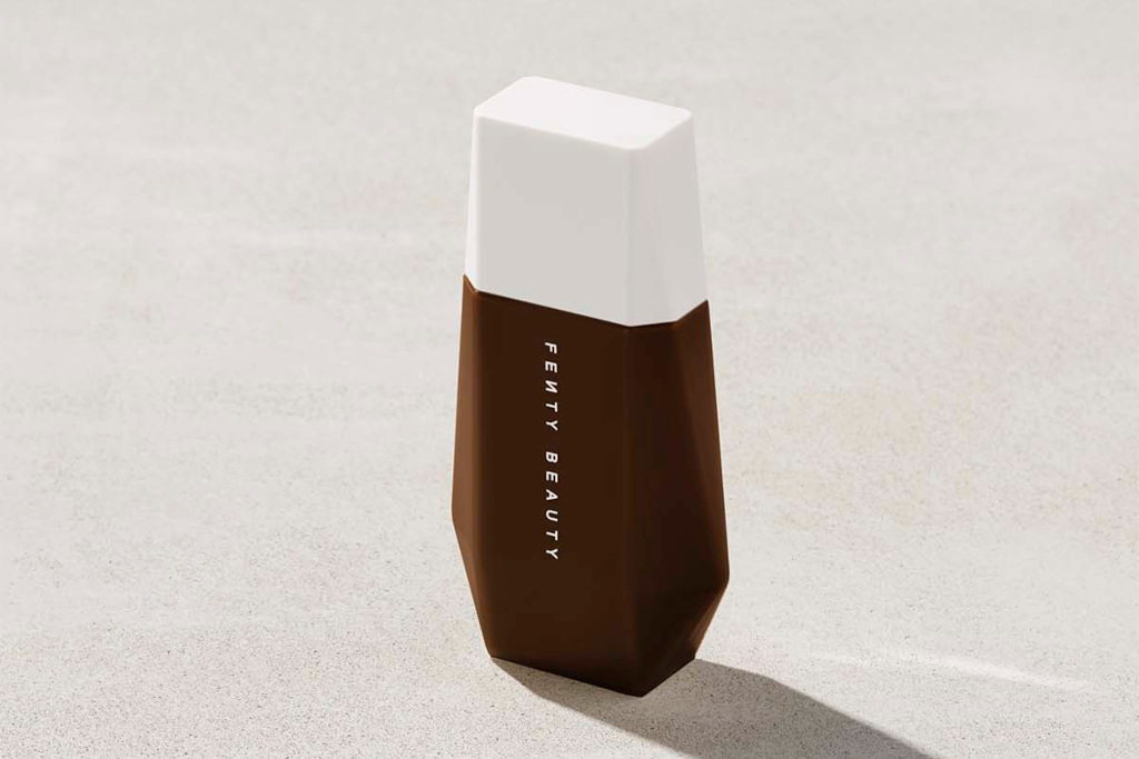 Bottle of makeup in dark shade with white lid