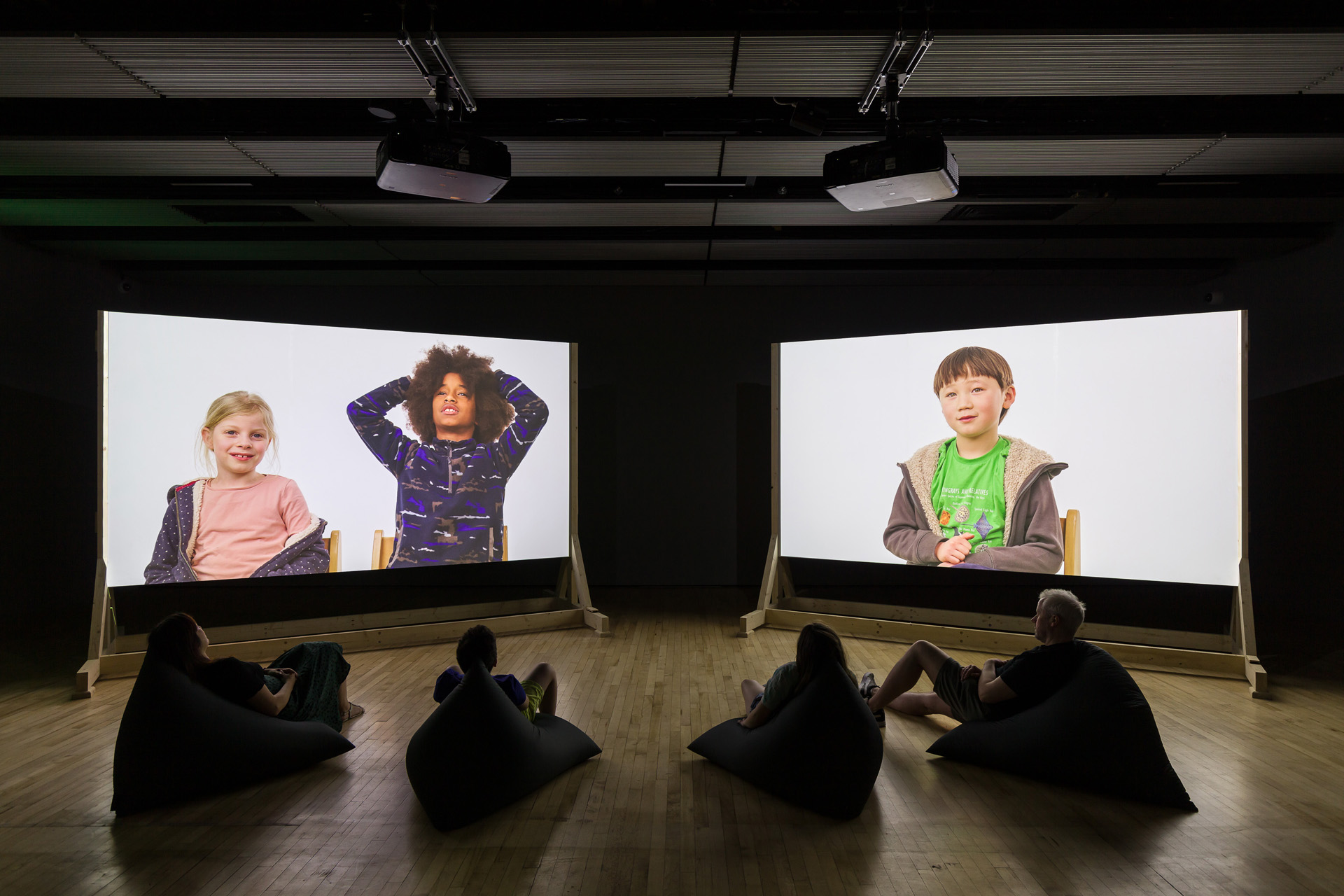 Installation view of Cornelia Parker - children on projected screens