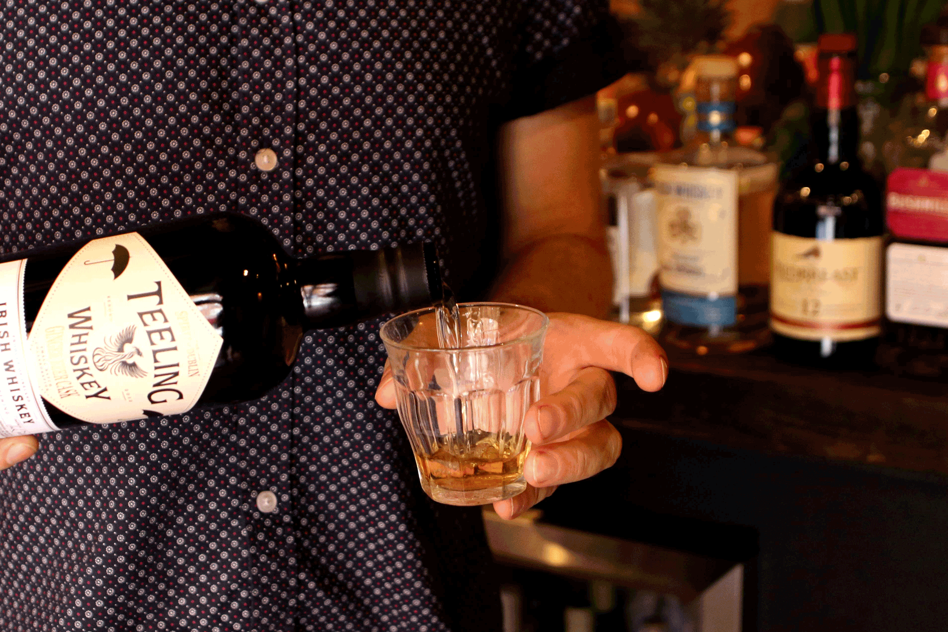 Man pouring whisky into a glass.