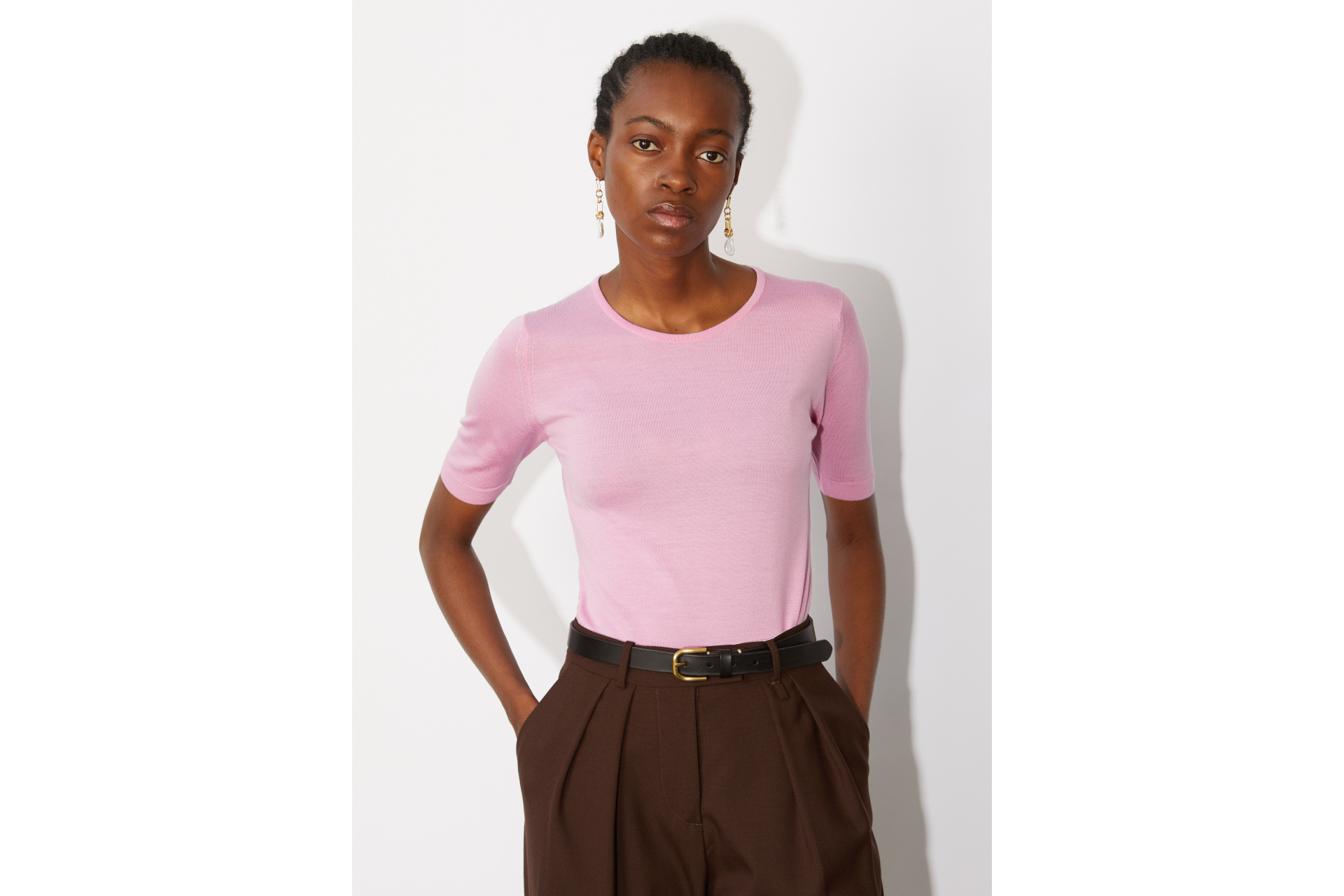 Woman in pink top and brown trousers