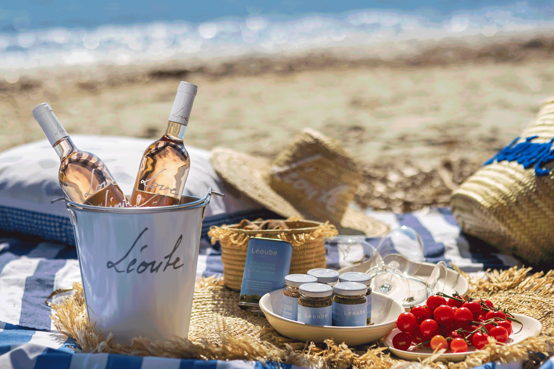 Leoube hamper on the beach, with wine, snacks and picnic blankets.