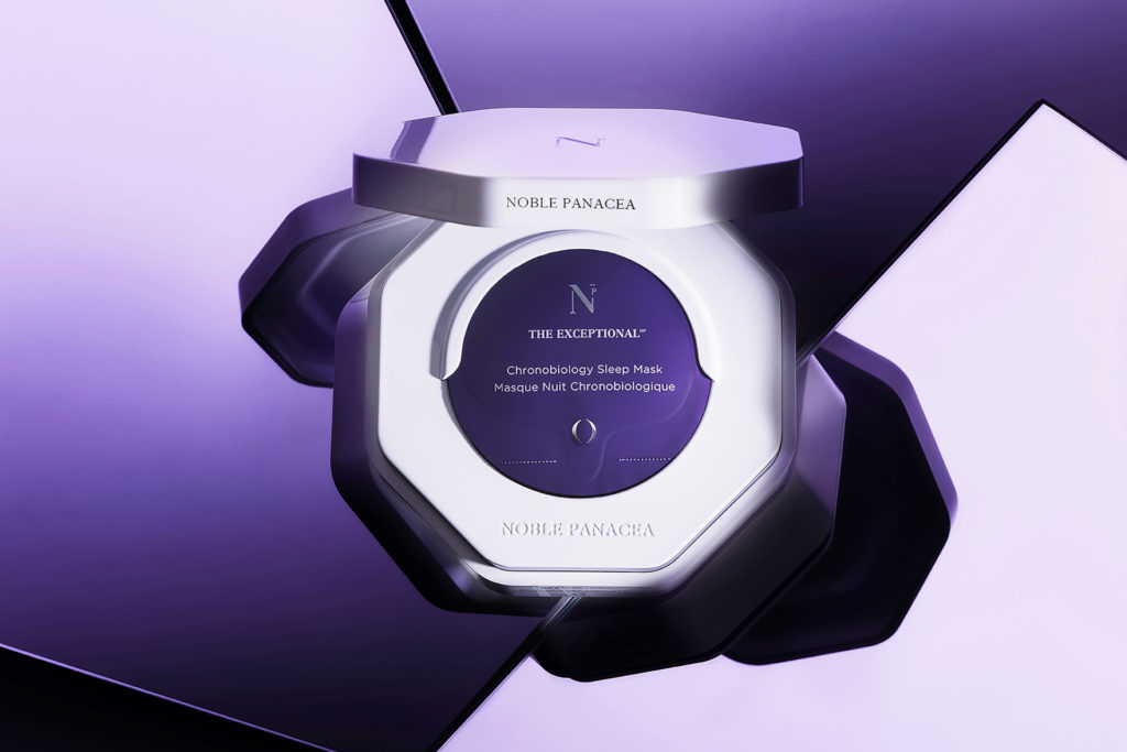White compact with face mask sachets inside on purple background