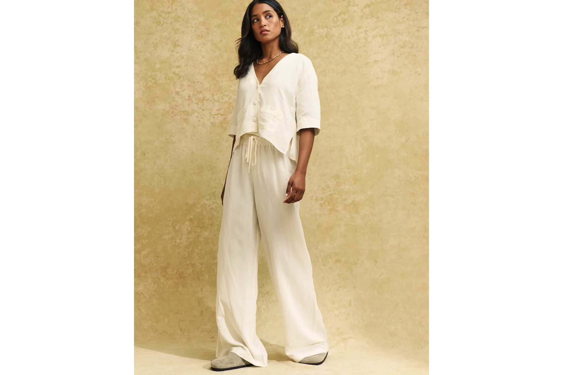 Cream linen-blend shirt worn with matching cream trousers.
