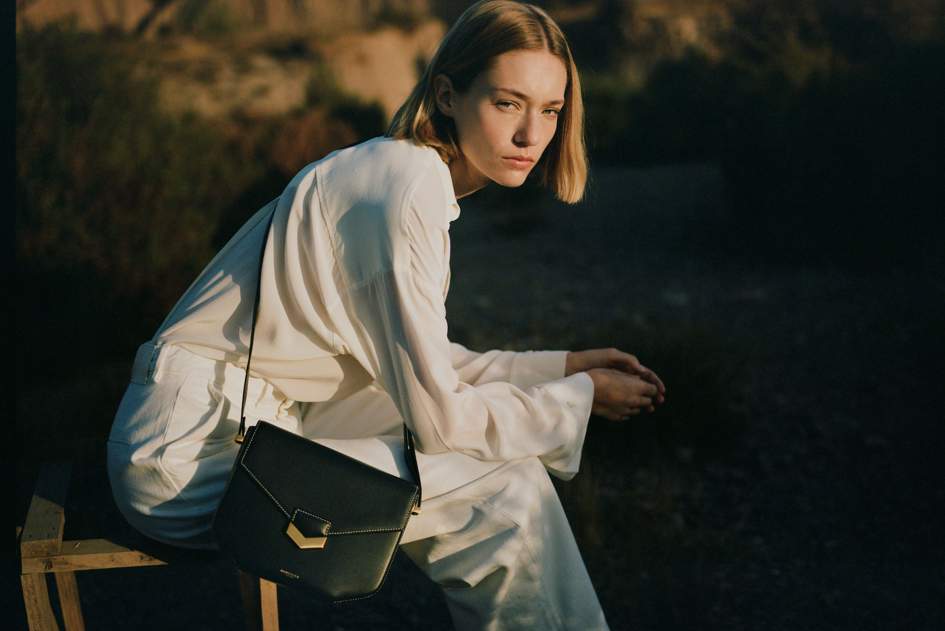 Model with DeMellier london bag