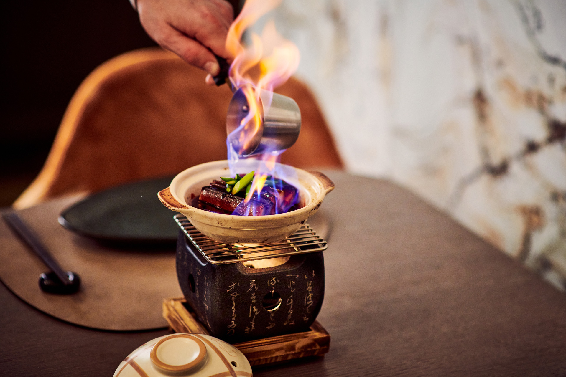 A flaming dish of food at Straits Kitchen