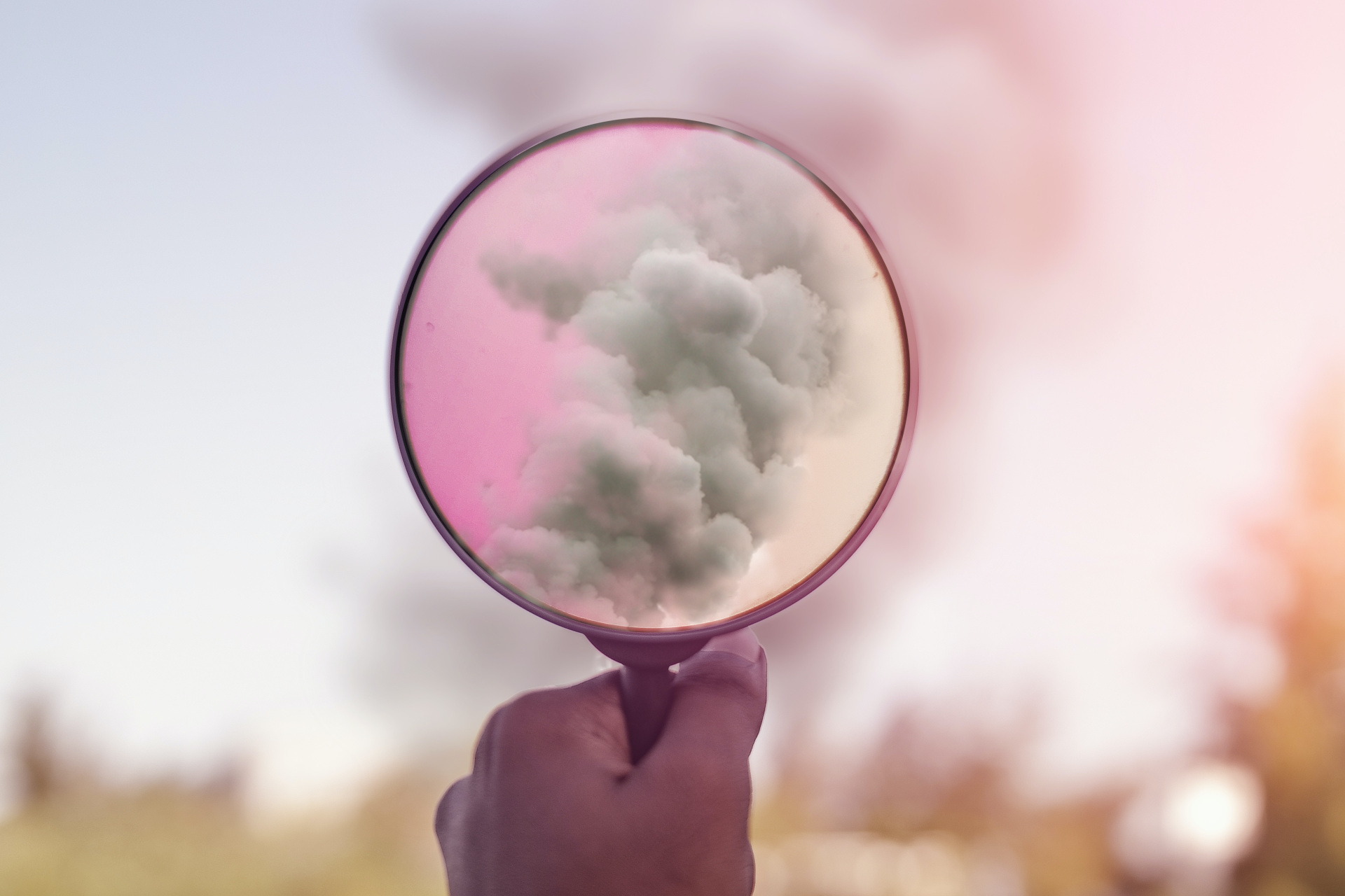 Magnifying glass looking at cloud of smoke