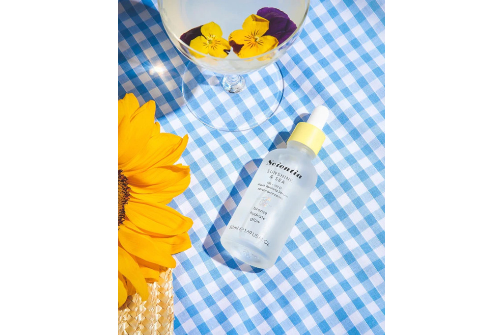 Clear bottle on blue gingham table cloth with sunflowes