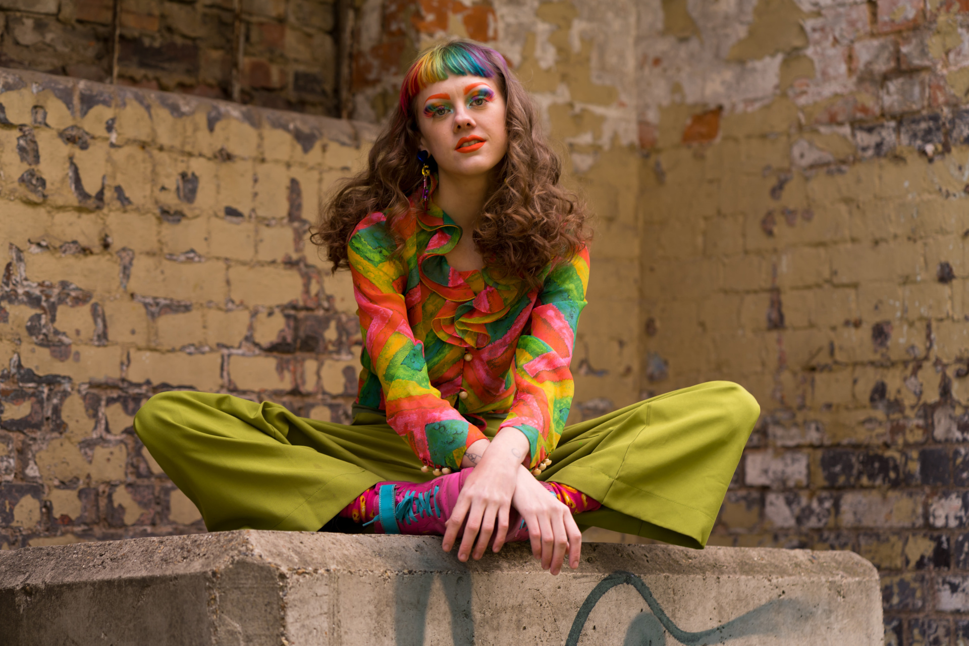 Woman wearing rainbow top and makeup