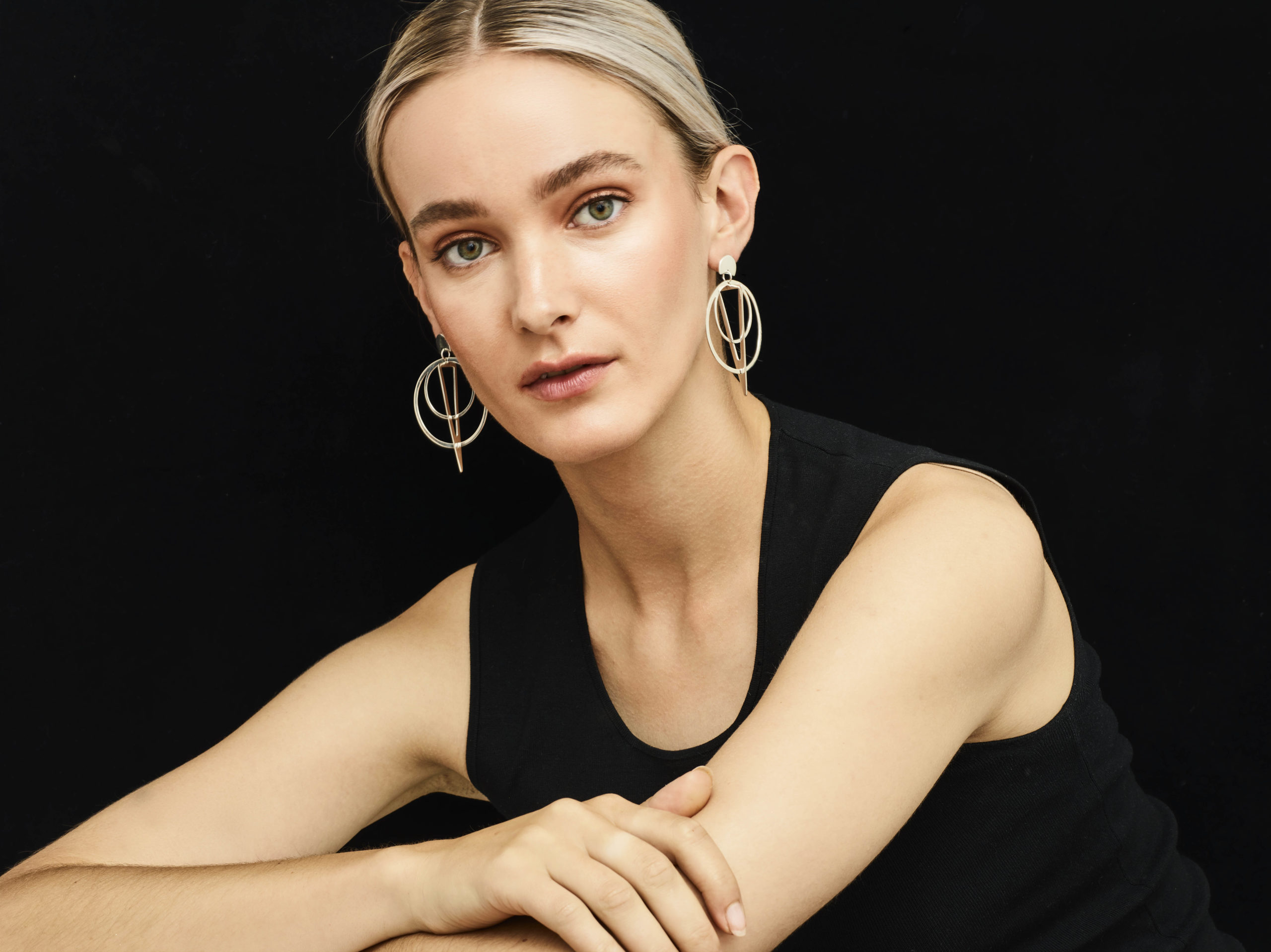 Toolally sundial earrings worn by blonde model