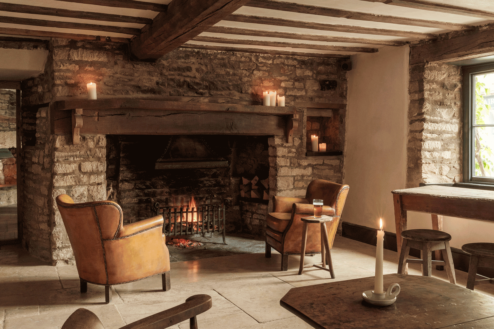 Rustic living room with ceiling beams and fireplace.